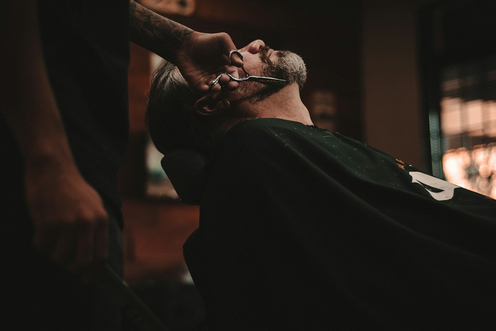 Barber shaping a customer's beard
